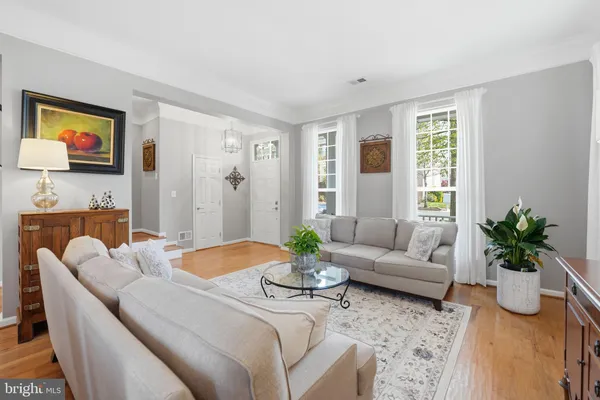 a living room with furniture potted plant and a window