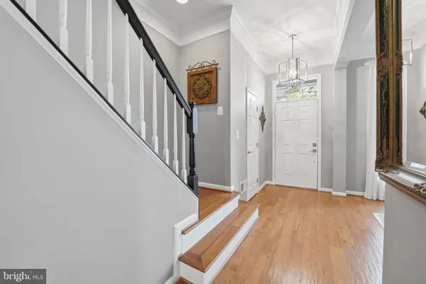 a view of a hallway with wooden floor and staircase