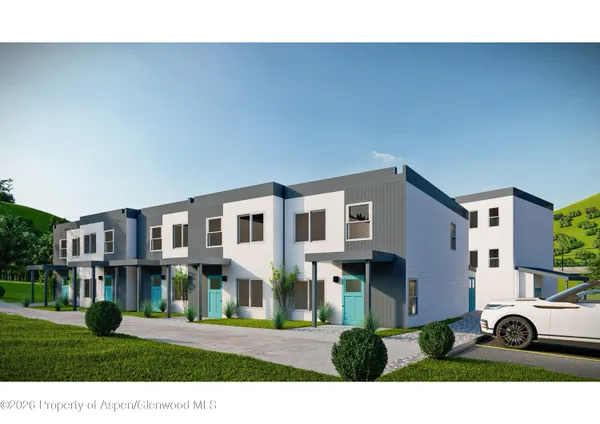 a view of multiple houses with a yard