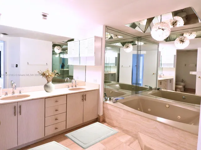 a spacious bathroom with a sink mirror and a bathtub