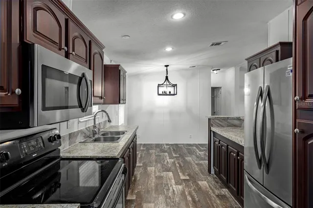 a view of washer and dryer with kitchen in the background