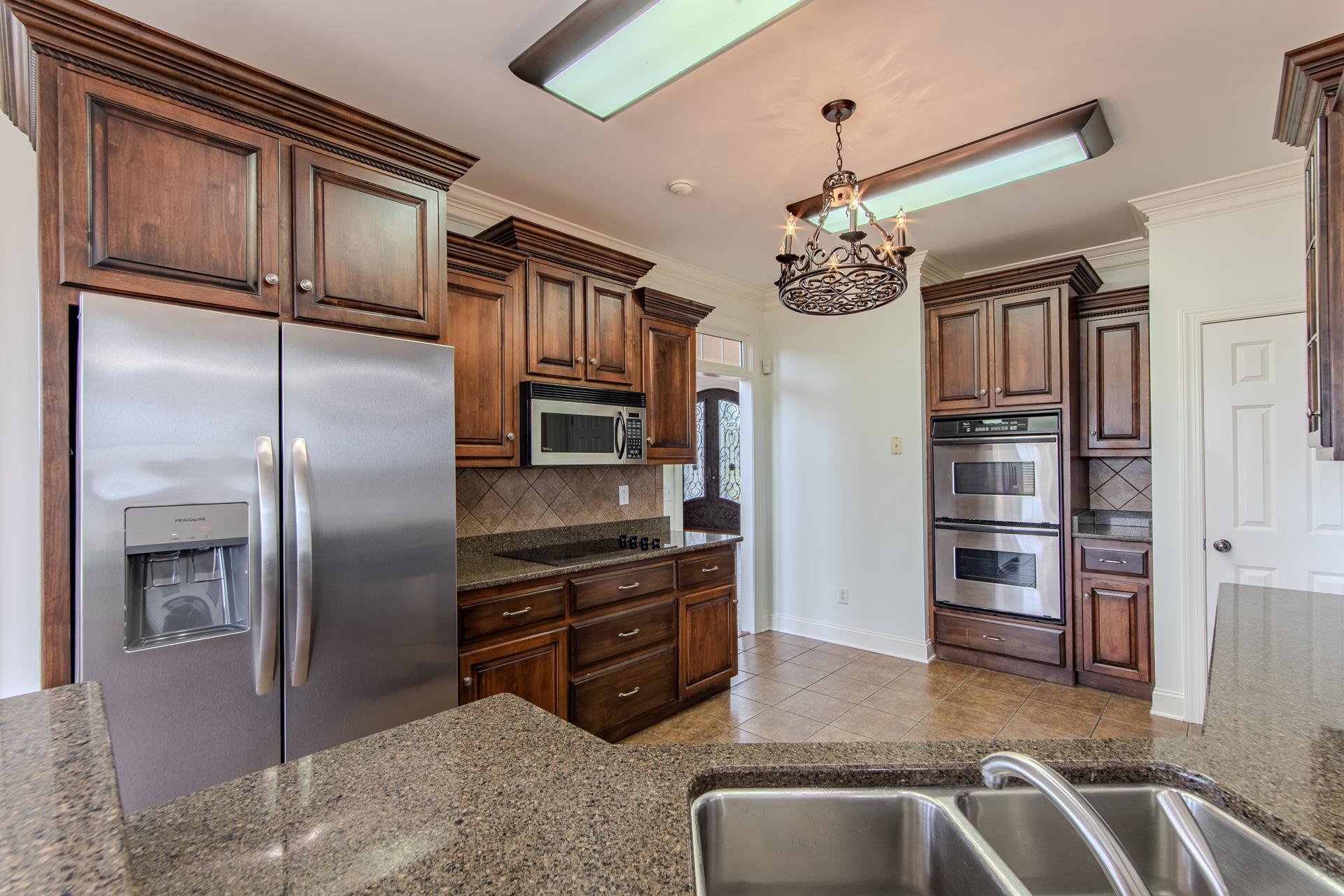 5166 Middlefork Road Luray, TN 38352 - Photo 11 of 40 a kitchen with stainless steel appliances granite countertop a refrigerator a stove and a sink