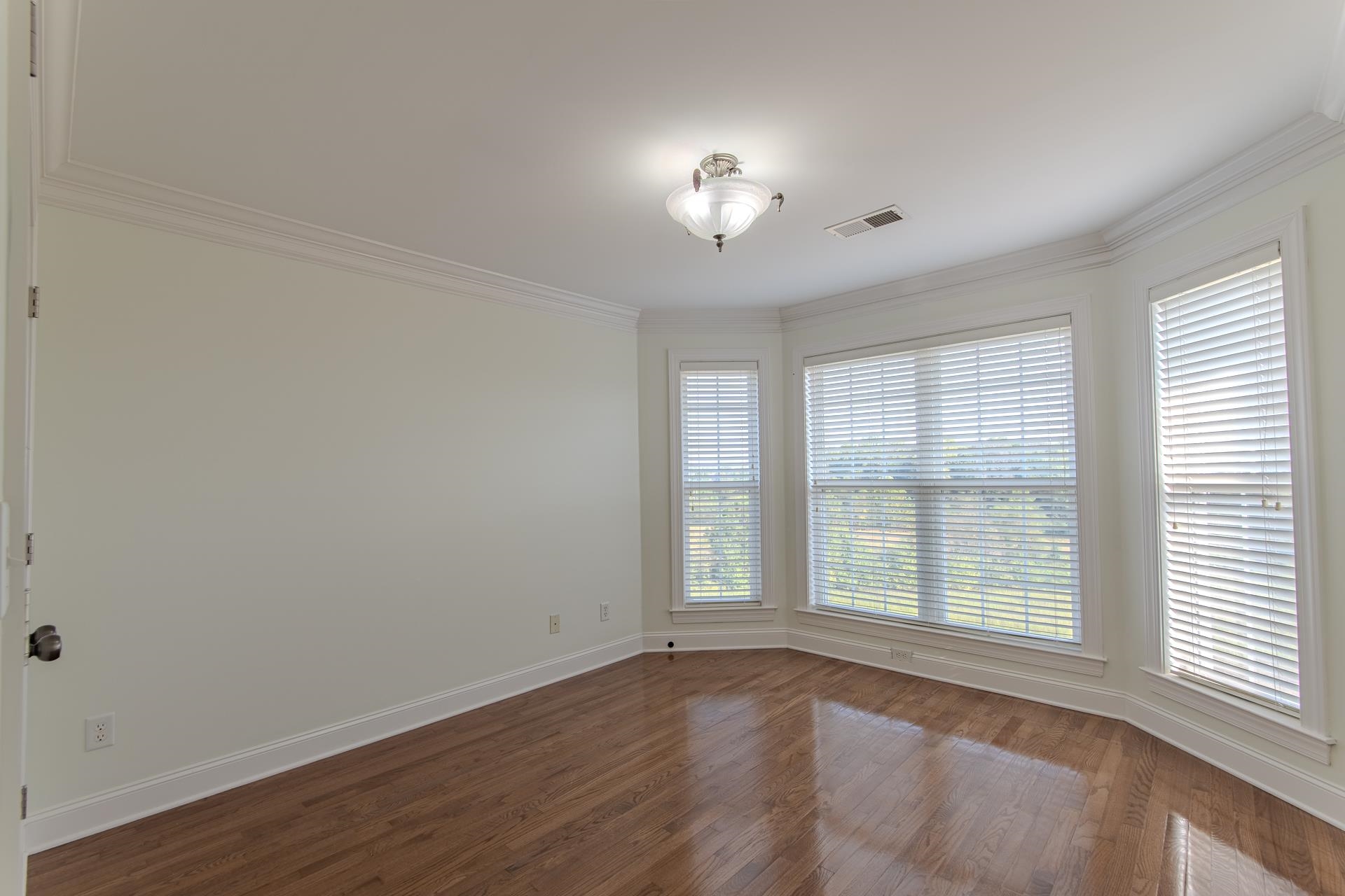 5166 Middlefork Road Luray, TN 38352 - Photo 29 of 40 an empty room with wooden floor and windows