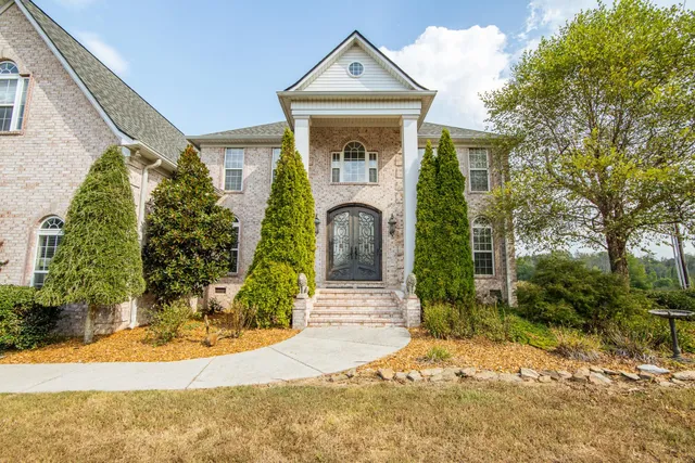 a front view of a house with garden