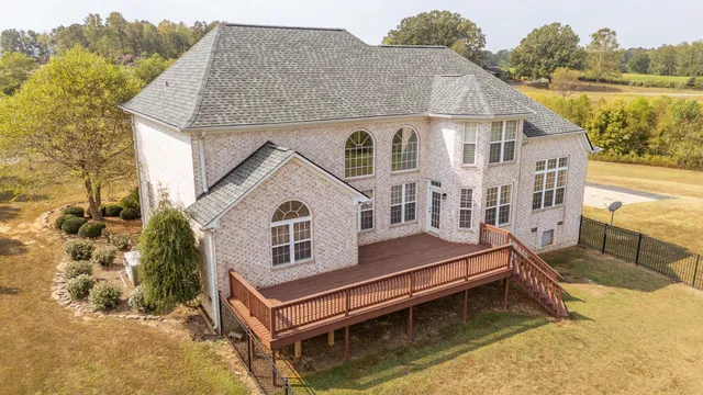 a aerial view of a house with a yard and balcony