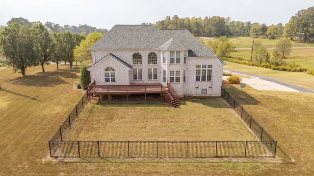 a view of a house next to a lake with mountain