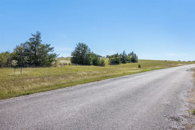 a view of a field with an ocean view