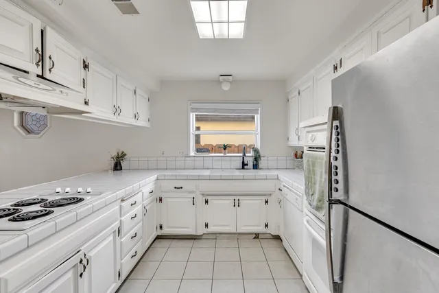 a kitchen with a stove a sink and a refrigerator