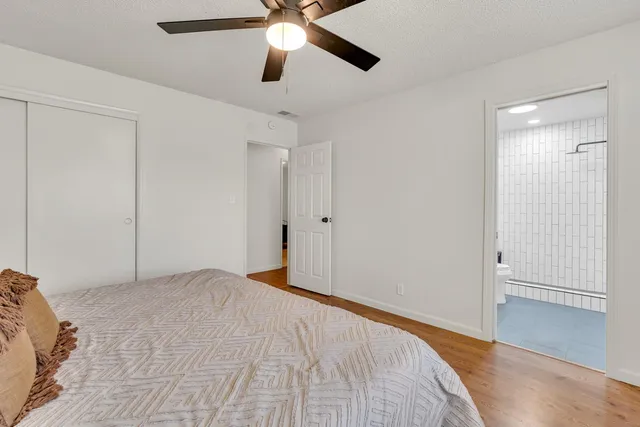 a view of an empty room with chandelier fan
