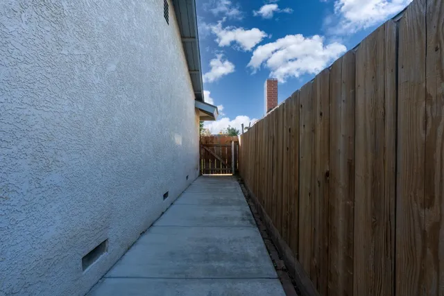 a view of a pathway with a wooden fence