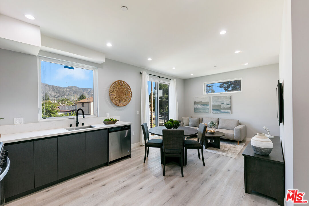 15106 Roxford Street, Unit 13621 Los Angeles, CA 91342 - Photo 18 of 22 a view of a dining room with furniture window and wooden floor