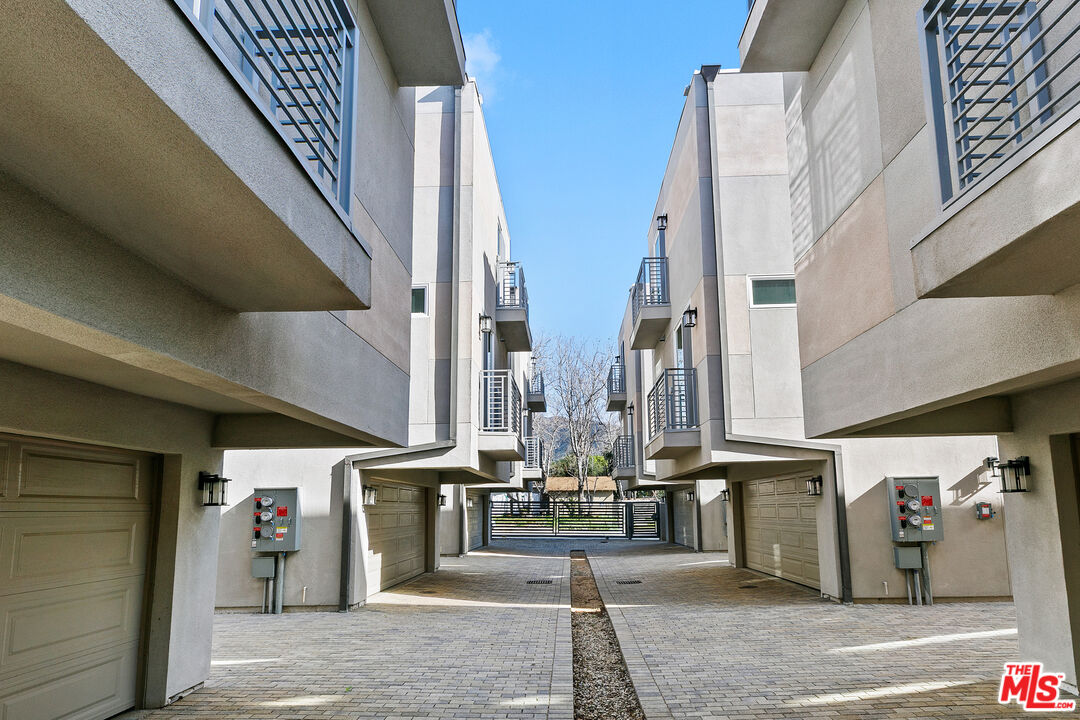 15106 Roxford Street, Unit 13621 Los Angeles, CA 91342 - Photo 2 of 22 a view of a building with traffic signal lights