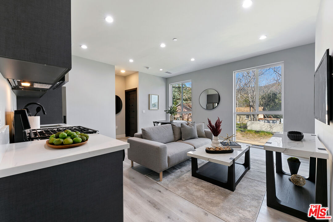 15106 Roxford Street, Unit 13621 Los Angeles, CA 91342 - Photo 6 of 22 a living room with furniture and a large window