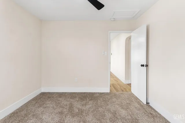 a view of an empty room and wooden floor