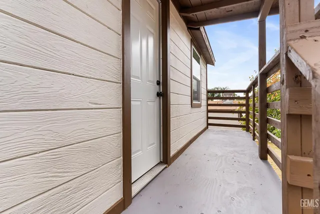 a kitchen with white cabinets appliances a sink and a window