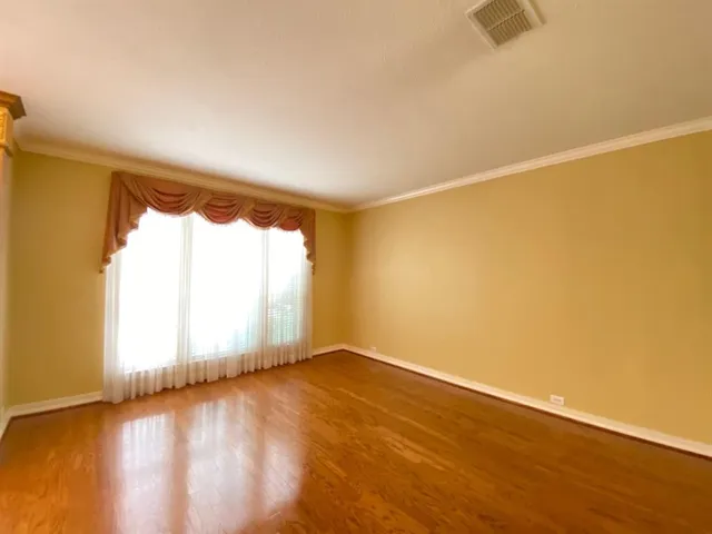 a view of an empty room with a fireplace and a window
