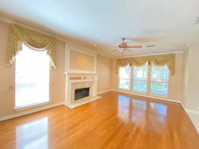 a large windows in a spacious bedroom next to a window