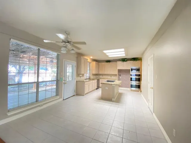 a kitchen with stainless steel appliances granite countertop a sink cabinets and stove top oven