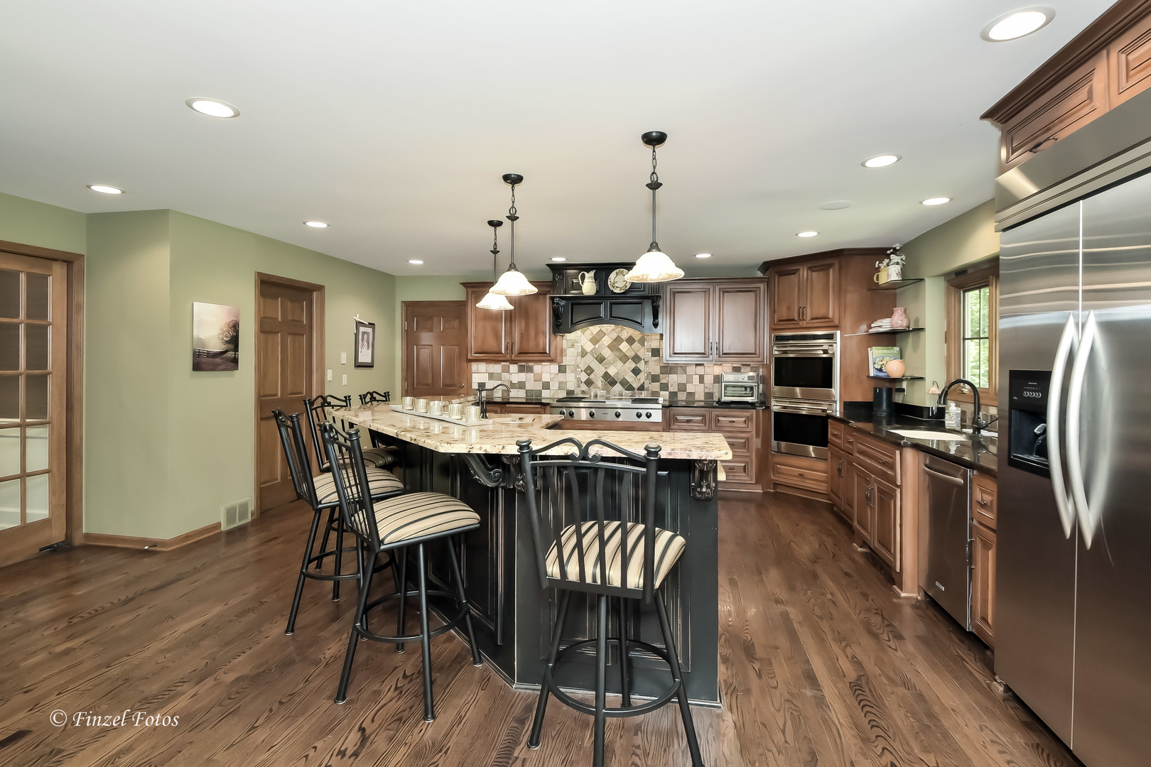 52 Bluff Road Trout Valley, IL 60013 - Photo 8 of 36 a kitchen with stainless steel appliances kitchen island granite countertop a table chairs and a refrigerator