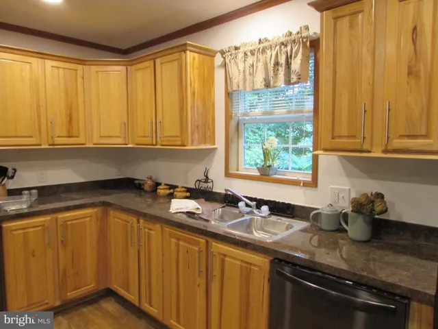 a kitchen with a sink a stove and cabinets