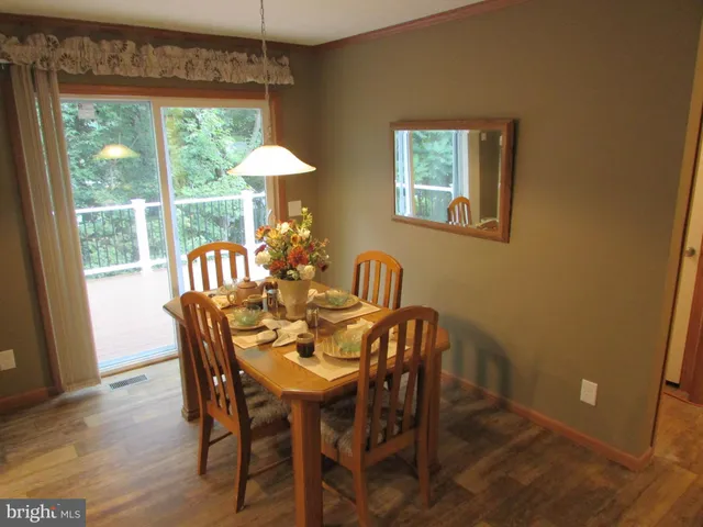 a dining room with furniture and a window