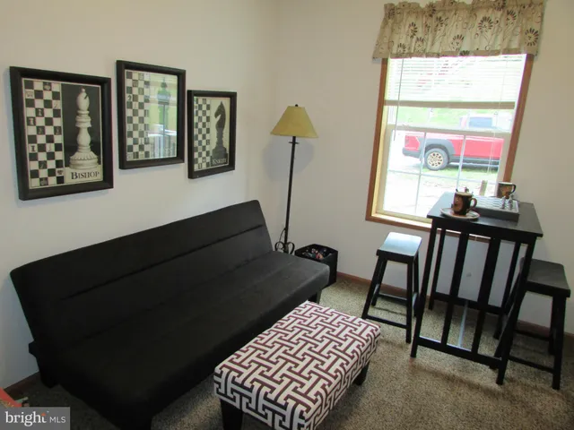 a view of a room with furniture and a window