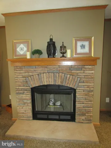 a fireplace with a clock on the wall