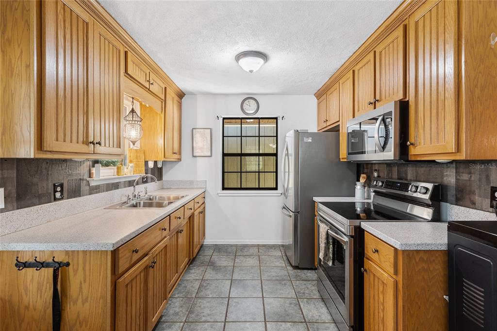 1069 Southeast Suwannee Trail Branford, FL 32008 - Photo 11 of 47 a kitchen with stainless steel appliances granite countertop a sink stove and cabinets