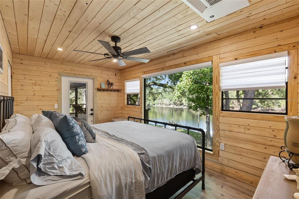 1069 Southeast Suwannee Trail Branford, FL 32008 - Photo 16 of 47 a bedroom with a bed and large windows