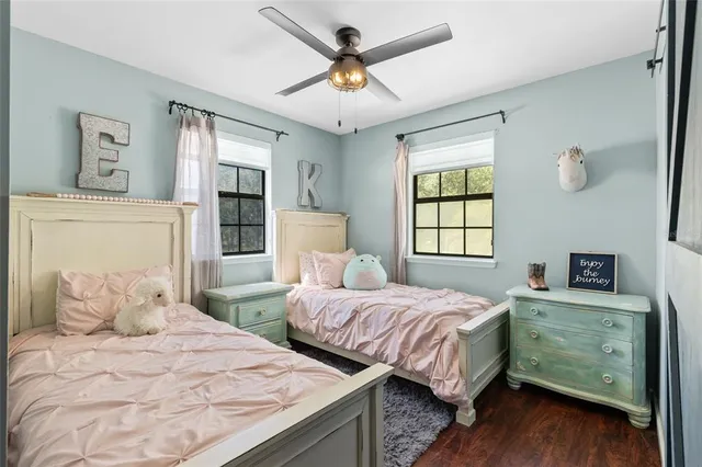 a bedroom with two beds and a chandelier