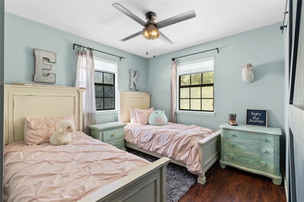 1069 Southeast Suwannee Trail Branford, FL 32008 - Photo 19 of 47 a bedroom with two beds and a chandelier