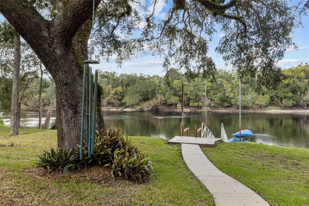 1069 Southeast Suwannee Trail Branford, FL 32008 - Photo 2 of 47 a view of a lake with a garden