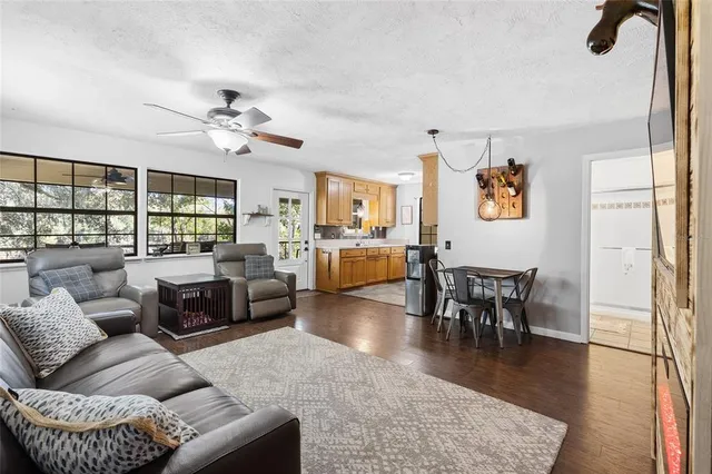 a living room with furniture a rug and a floor to ceiling window