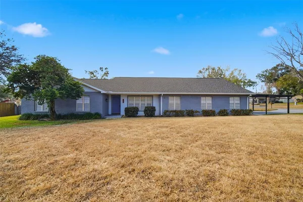 a view of a dining room with furniture a fireplace and wooden floor