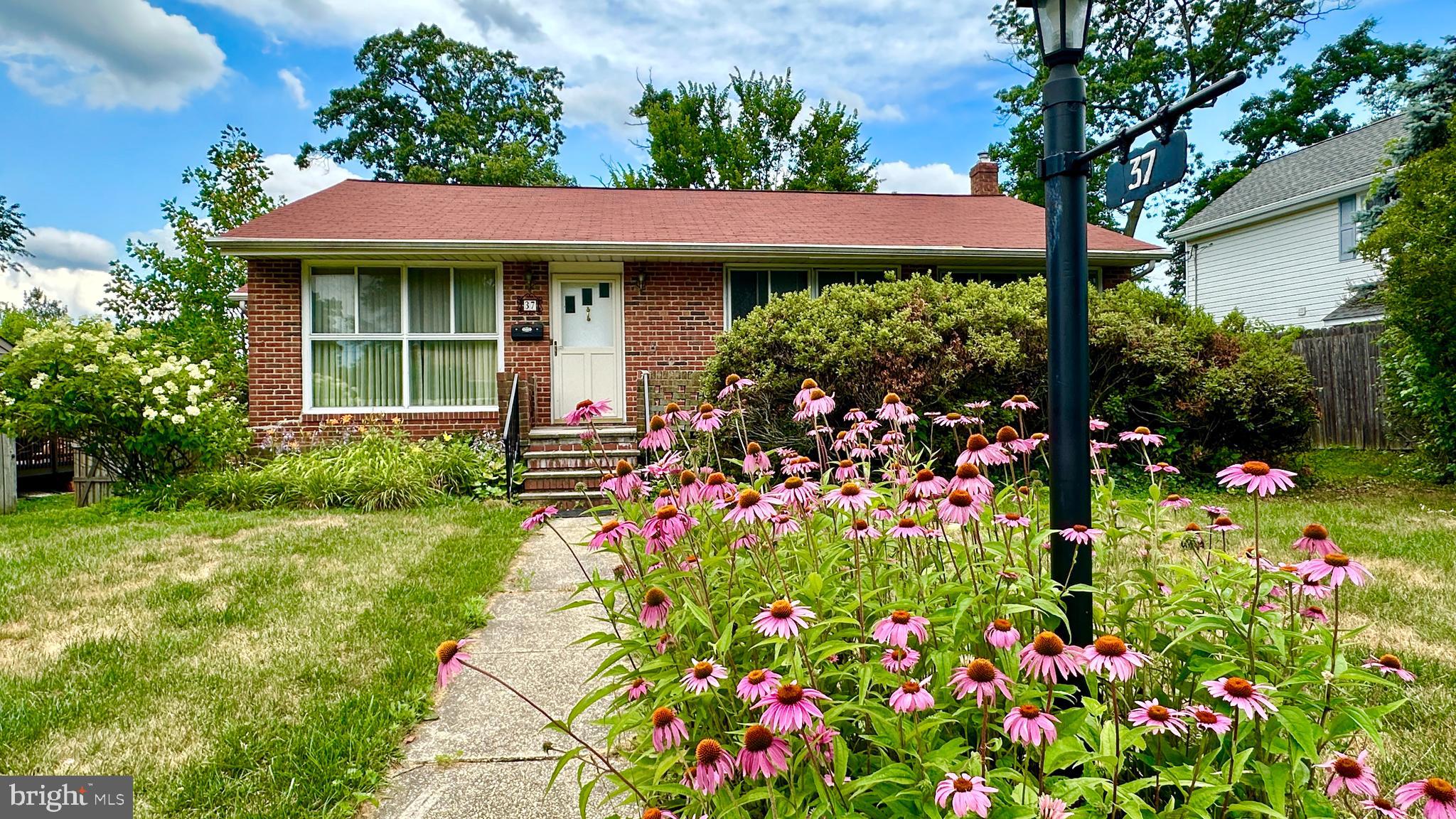 a view of a house with a flower garden