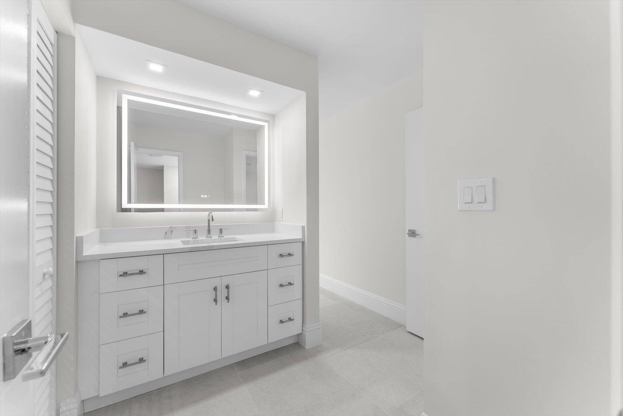6562 Boca Del Mar Drive, Unit 222 Boca Raton, FL 33433 - Photo 12 of 39 a bathroom with a sink and a mirror