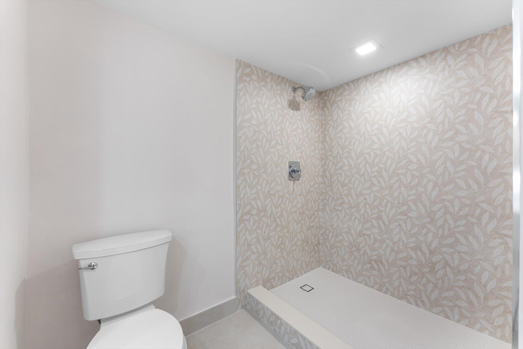 6562 Boca Del Mar Drive, Unit 222 Boca Raton, FL 33433 - Photo 14 of 39 a bathroom with a toilet and a shower