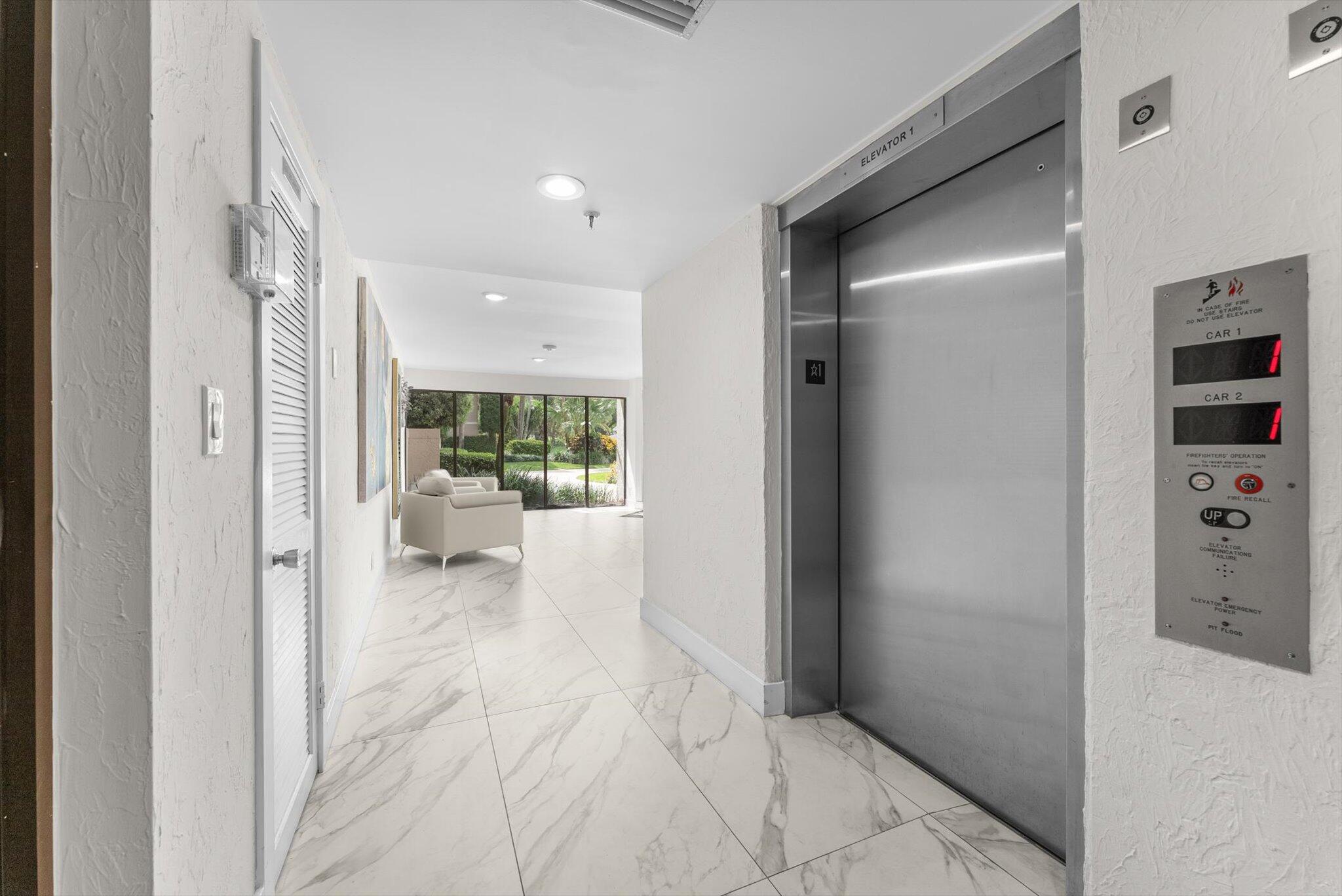 6562 Boca Del Mar Drive, Unit 222 Boca Raton, FL 33433 - Photo 25 of 39 a view of a hallway with a living room