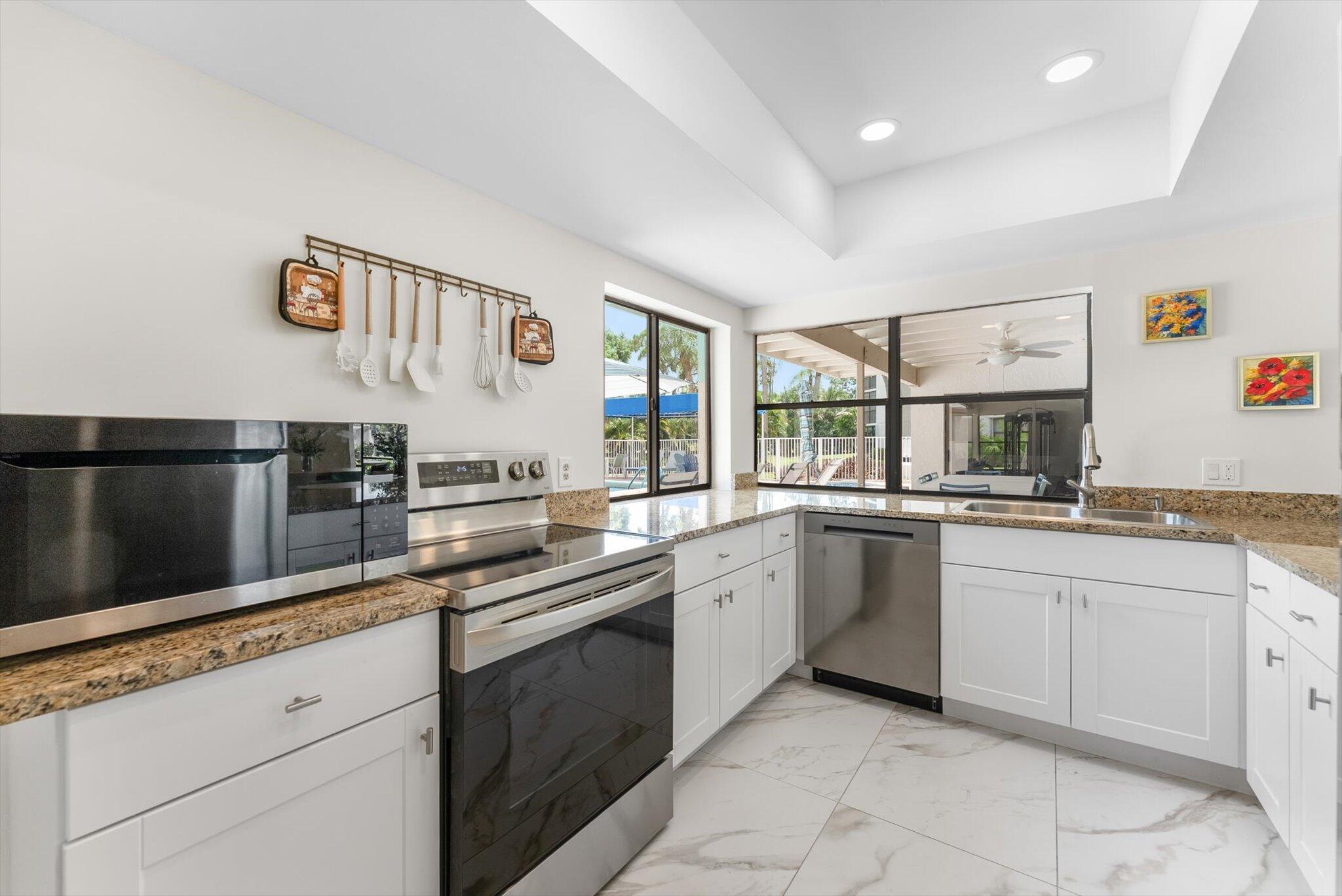 6562 Boca Del Mar Drive, Unit 222 Boca Raton, FL 33433 - Photo 27 of 39 a kitchen with a sink and cabinets