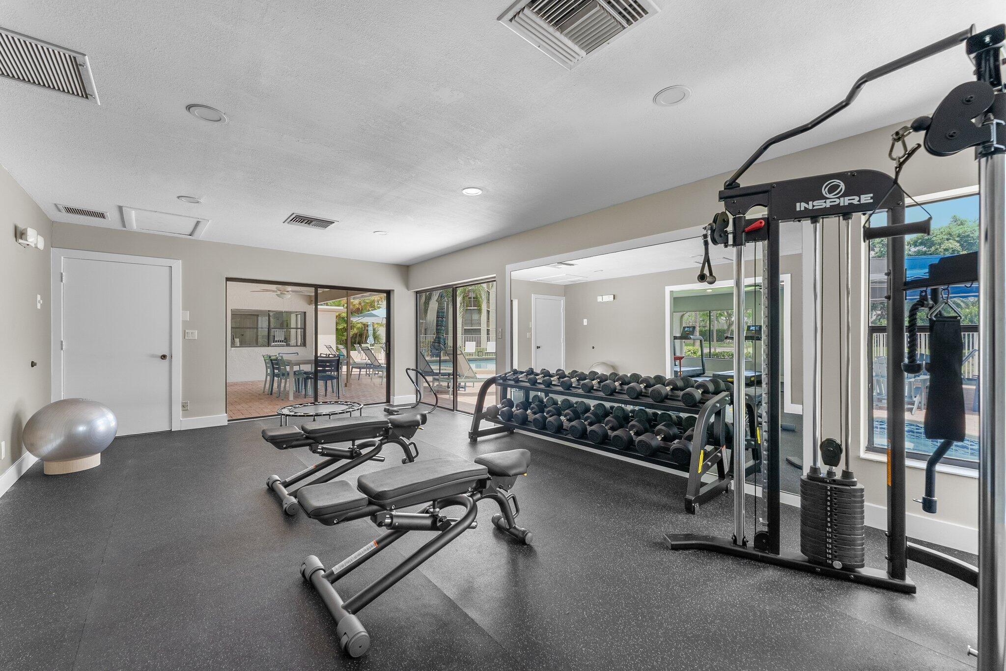 6562 Boca Del Mar Drive, Unit 222 Boca Raton, FL 33433 - Photo 29 of 39 a living room with furniture a window and gym equipment