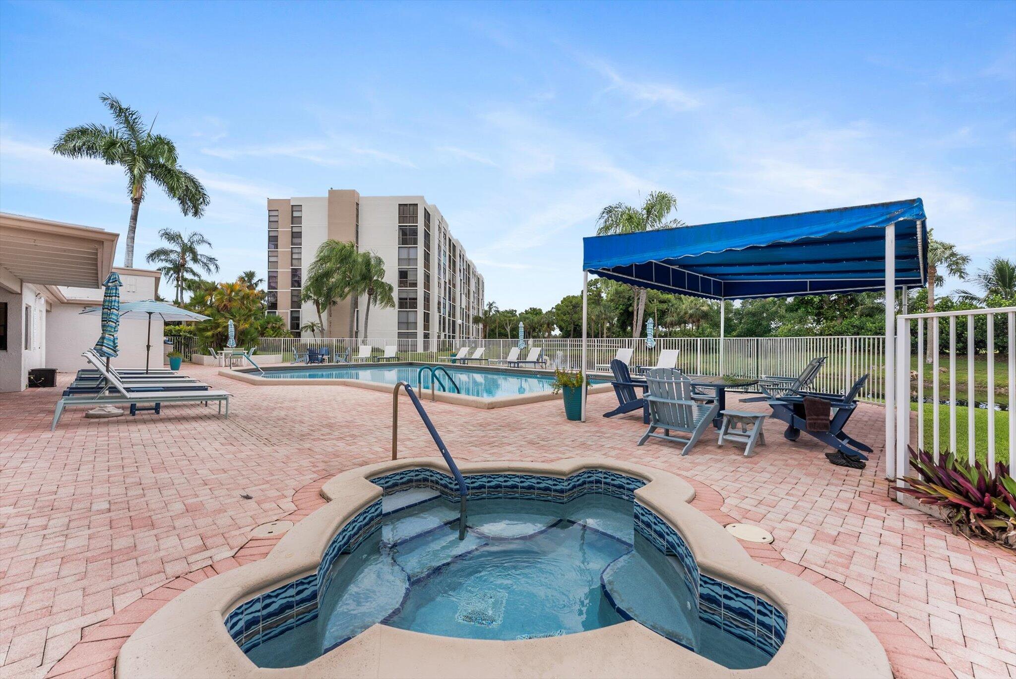 6562 Boca Del Mar Drive, Unit 222 Boca Raton, FL 33433 - Photo 31 of 39 a view of a swimming pool with a lounge chair