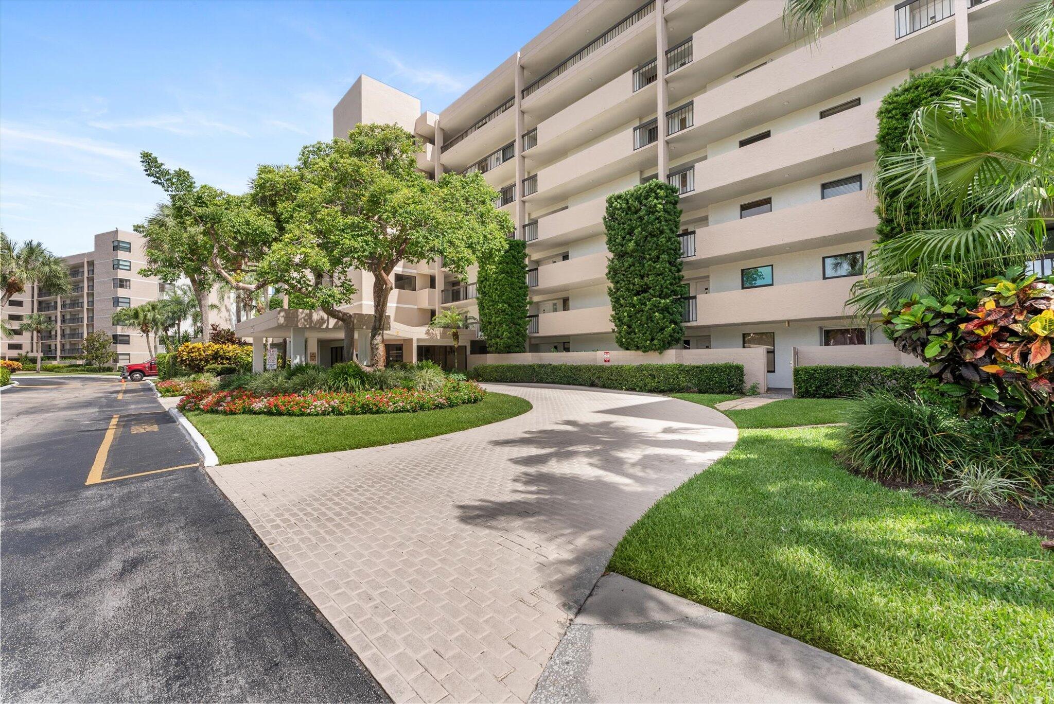 6562 Boca Del Mar Drive, Unit 222 Boca Raton, FL 33433 - Photo 36 of 39 a view of a white house with a yard