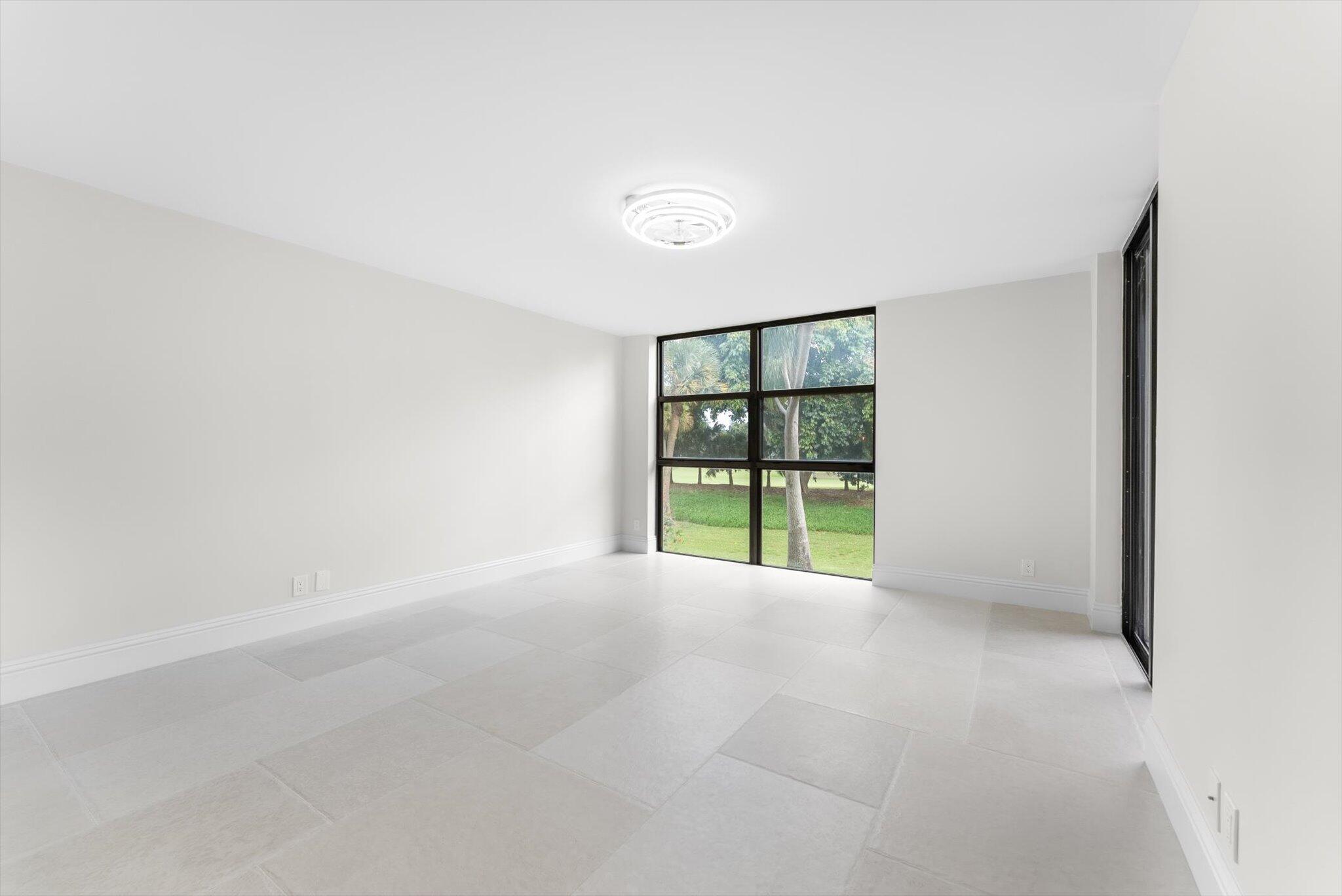 6562 Boca Del Mar Drive, Unit 222 Boca Raton, FL 33433 - Photo 10 of 39 a view of an empty room with a window and stairs