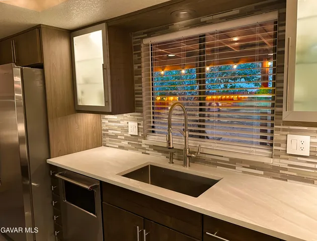 a kitchen with a sink and large window