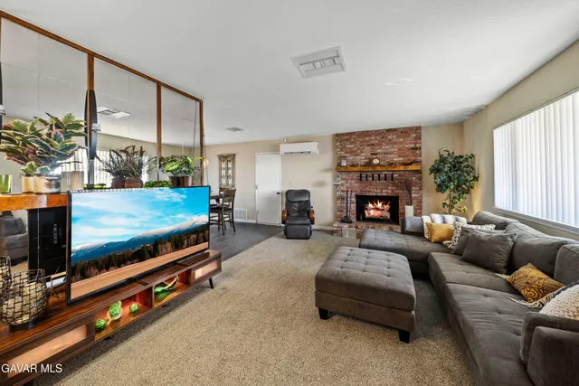 a living room with furniture fireplace and flat screen tv