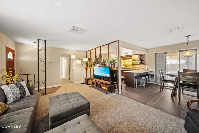 a bedroom with furniture and a large window