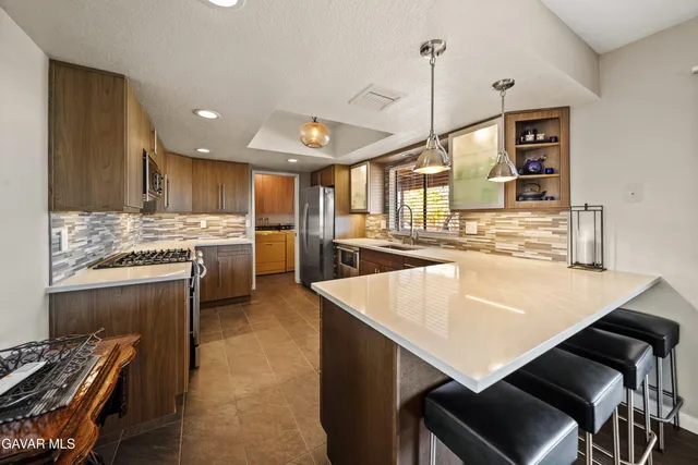 a kitchen with a stove a sink and a refrigerator