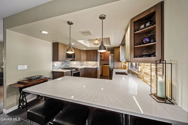 a view of a kitchen with a table and chairs