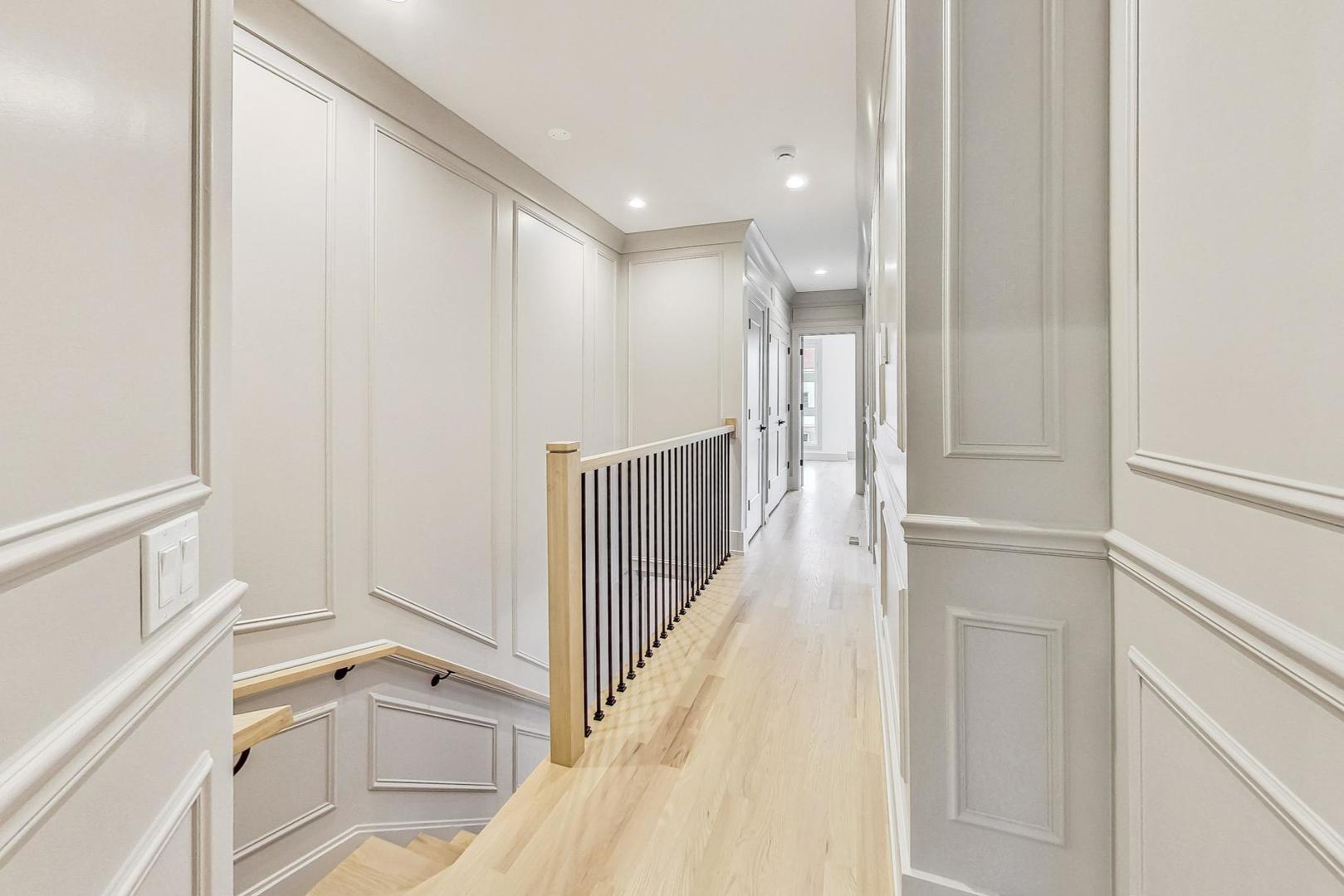 4244 South Champlain Avenue Chicago, IL 60653 - Photo 13 of 34 a view of a hallway with white walls and stairs