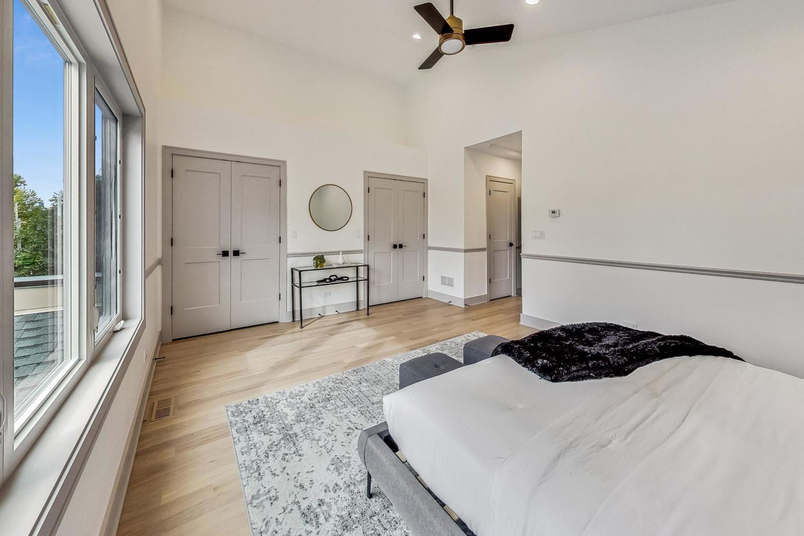 4244 South Champlain Avenue Chicago, IL 60653 - Photo 15 of 34 a bedroom with a bed and wooden floor